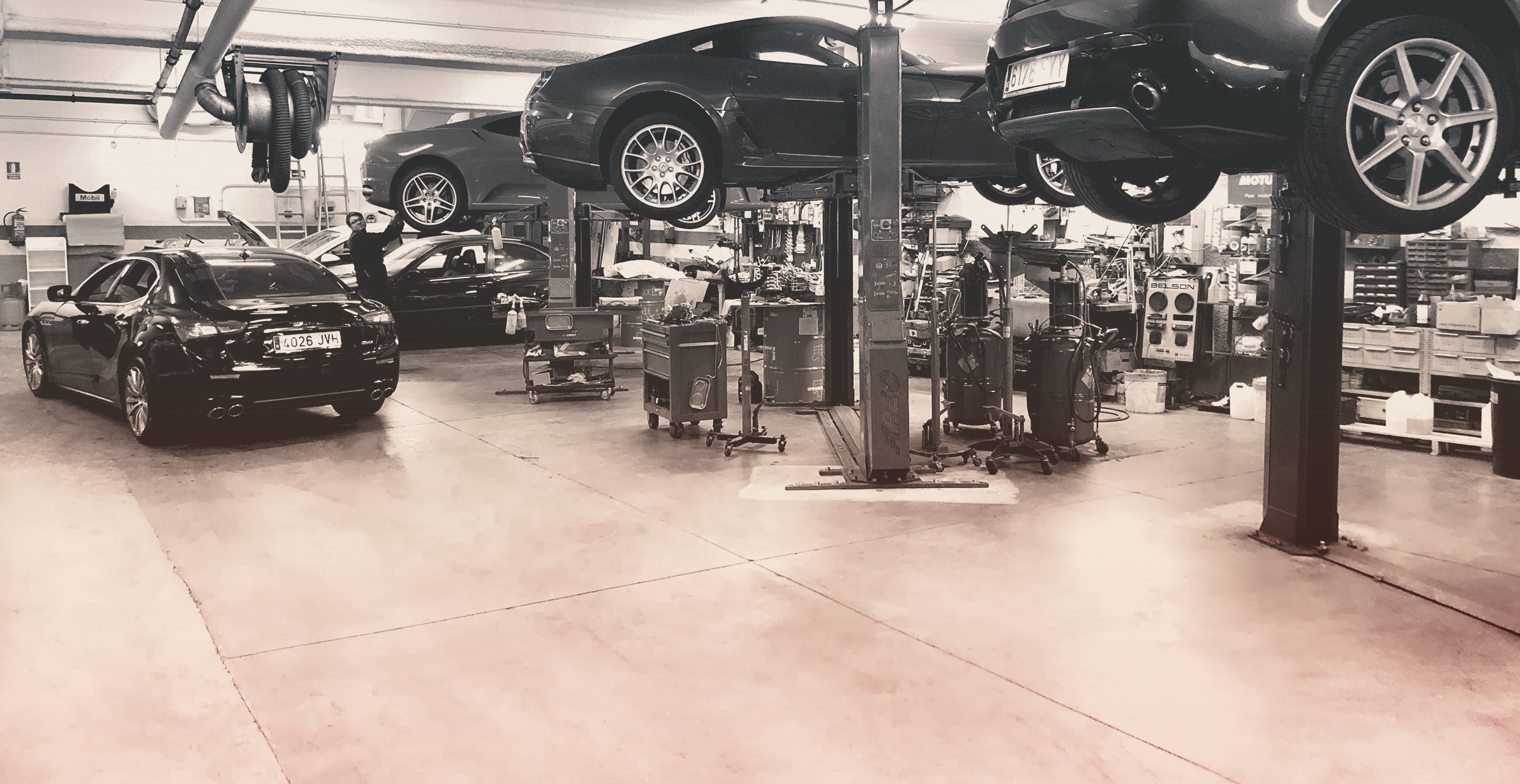 Auto shop with several cars on lifts